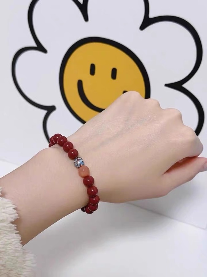 Customer-shared photo of a red cinnabar bead bracelet on wrist